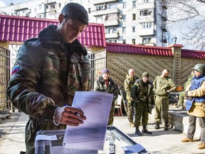 Pro-Russian rebel commander Mikhail Tolstykh casts his ballot during elections on the front line near Donetsk airport in the city of Donetsk, eastern Ukraine Nov. 2, 2014.