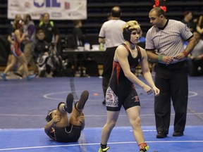 Mack Beggs, right, a transgender wrestler from Euless Trinity, is shown during a quarterfinal against Mya Engert of Amarillo Tascosa during the state wrestling tournament Friday, Feb. 24, 2017, in Cypress, Texas. Beggs, who has transitioned to being a male, wants to compete in the boys' division but isn't allowed.