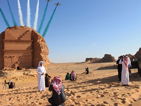 Saudi visitors watch an aerial flying display over Mada'in Saleh, a UNESCO World Heritage Site in Saudi Arabia.