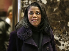 Omarosa Manigault smiles at reporters as she walks through the lobby of Trump Tower in New York, Tuesday, Dec. 13, 2016