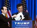 Donald Trump's former campaign chairman Paul Manafort, right, checks the podium before a campaign event in June 2016 in New York City.