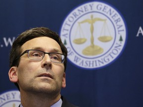 Washington Attorney General Bob Ferguson listens to a question at a news conference about a federal appeals court's refusal to reinstate President Donald Trump's ban on travelers from seven predominantly Muslim nations.