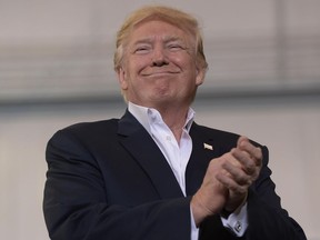 President Donald Trump smiles as he prepares to speak at his "Make America Great Again Rally" at Orlando-Melbourne International Airport in Melbourne, Fla., Saturday, Feb. 18, 2017.