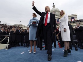 U.S. President Donald Trump waves to the audience after taking the oath of office