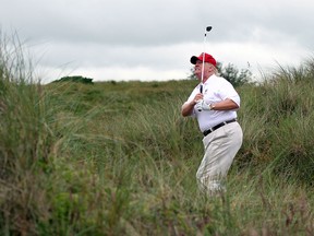 Donald Trump plays a round of golf after the opening of The Trump International Golf Links Course on July 10, 2012, in Balmedie, Scotland.