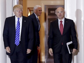 In this Nov. 19, 2016 file photo, then-President-elect Donald Trump walks Labor Secretary-designate Andrew Puzder from Trump National Golf Club Bedminster clubhouse in Bedminster, N.J. Four Republicans on the Senate committee considering President Donald Trumpís nominee for secretary of labor aren't saying publicly if they will vote for him.