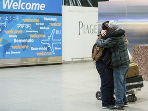 Abdullah Alghazali, right, hugs his 13-year-old son Ali Abdullah Alghazali after the Yemeni boy stepped out of an arrival entrance at John F. Kennedy International Airport in New York, Sunday, Feb. 5, 2017.