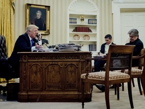 U.S. President Donald Trump, left, speaks on the phone with Malcolm Turnbull, Australia's prime minister, Jan 28. 2017