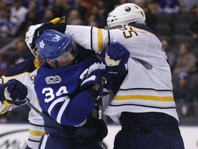Buffalo Sabres defenceman Rasmus Ristolainen (right) roughs up Toronto Maple Leafs forward Auston Matthews on Feb. 11.
