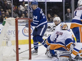 Maple Leafs centre Auston Matthews watches the puck enter the net behind New York Islanders netminder Thomas Greiss for a goal during their game in Toronto on Tuesday night.