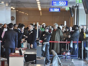 Passengers of a Turkish Airlines flight to Toronto, Canada, wait at the boarding gate in Istanbul's Ataturk international airport, Saturday, Feb. 18, 2017. A Turkish Airlines plane in Istanbul was evacuated Saturday after a suspicious note was discovered in one of its bathrooms. ?The Turkish Airlines cabin crew found the words "BOMB TO TORONTO" on the bathroom's wall on Flight TK-17 during its pushback from the gate, a Turkish Airlines press official told The Associated Press.