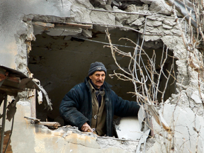 A municipal worker inspects damage to a home that was hit by a shell in the city of Donetsk, Ukraine, Feb. 1, 2017.