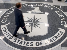 A man walks over the seal of the Central Intelligence Agency (CIA) in the lobby of CIA Headquarters in Langley, Virginia