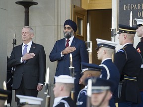 U.S. Defense Secretary Jim Mattis and Canadian Defense Minister Harjit Sajjan stand for the National Anthem of the United States during an Honor Cordon at the Pentagon., Monday, Feb. 6, 2017.