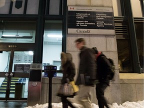 Pedestrians walk past the Citizenship and Immigration Canada and Canada Border Services Agency offices in Montreal on Wednesday January 6, 2016.
