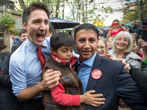 Liberal leader Justin Trudeau with Arif Virani and his son during a campaign stop on Oct. 13, 2015 in Toronto.