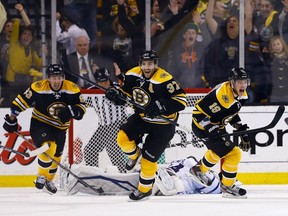 In this May 13, 2013 file photo, Brad Marchand (left), Patrice Bergeron (centre) and Tyler Seguin  celebrate Bergeron's series-winning overtime goal against the Toronto Maple Leafs.