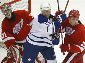 In this Feb. 27, 2003 file photo, Toronto Maple Leafs forward Mats Sundin (centre) jousts with Detroit Red Wings forward Darren McCarty (right) in front of goaltender Curits Joseph at Joe Louis Arena.