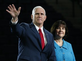Vice President Mike Pence, accompanied by his wife, Karen, waves after speaking at Liberty University in Lynchburg, Va., Oct. 12, 2016.