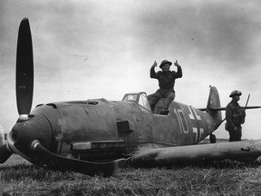 British soldiers guarding a Messerschmitt aeroplane