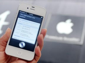 A woman displays "Siri", voice-activated assistant technology, on an Apple iPhone 4S in Taipei on July  30, 2012. Taiwan's National Cheng Kung University has filed a suit against US tech giant Apple, claiming the company's Siri intelligent assistant has infringed on two of its patents.