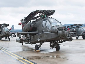 Apache attack helicopters of the U.S. Army stand on the tarmac after arriving at the Air Base in Ramstein, western Germany, on February 22, 201