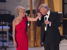 Donald J. Trump kisses the hand of campaign manager Kellyanne Conway at the Indiana Society Ball to thank donors January 19, 2017 in Washington, DC.