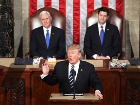 U.S. President Donald Trump addresses a joint session of the U.S. Congress as Vice President Mike Pence (L) and House Speaker Rep. Paul Ryan (R) (R-WI) look on.
