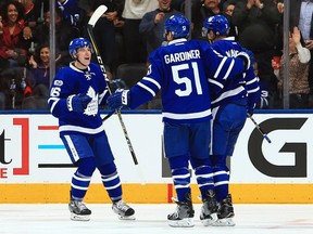Mitchell Marner, left, and Jake Gardiner celebrate a goal by Maple Leafs teammate Alexey Marchenko during their game against the Detroit Red Wings at Air Canada Centre in Toronto on Tuesday night.
