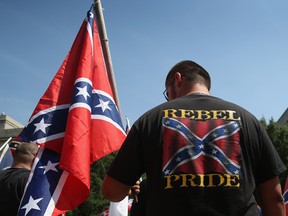 Ku Klux Klan members take part in a demonstration at the state house building on July 18, 2015 in Columbia, South Carolina.