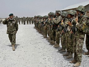 Afghan National Army soldiers stand in position, in the Sangin district of Kandahar province, southern Afghanistan, June 13, 2013.