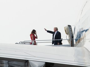 US President Donald Trump and First Lady Melania Trump board Air Force One in West Palm Beach, Florida, on February 18, 2017 to attend a rally in Melbourne, Florida.