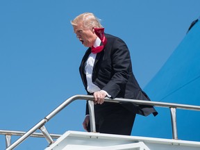 US President Donald Trump departs off Air Force One after arriving in Orlando, Florida, on March 3, 2017, before heading to St. Andrew Catholic School.