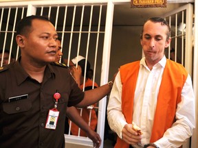 Britain national David Taylor (R) is escorted from a holding cell to the court room for his trial in Denpasar on Indonesia's resort island of Bali on March 13, 2017