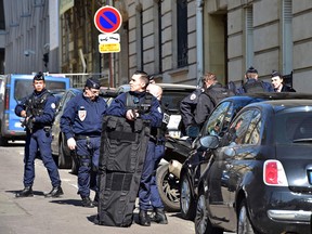 Police officers secure the area near the Paris offices of the International Monetary Fund (IMF) on March 16, 2017 in Paris