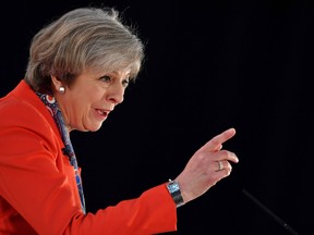British Prime Minister Theresa May gestures as she delivers her address to delegates at the Conservative Party Spring Conference in Cardiff, south Wales, on March 17, 2017