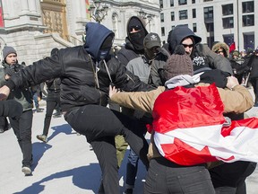 Two groups of protesters clash during a demonstration regarding motion M-103 in Montreal, Saturday, March 4, 2017.