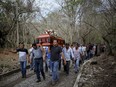 In this March 8, 2017 photo, members of the Solecito search group carry the coffin of Pedro Huesca, a police detective who disappeared in 2013 and was recently found in a mass grave