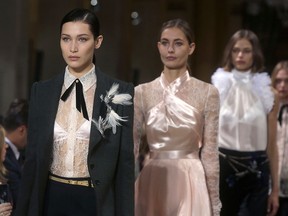 Model Bella Hadid, left, walks the runway at Lanvin's Fall 2017 collection show as part of Paris Fashion Week on March 1, 2017.