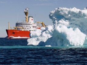 The Canadian Coast Guard icebreaker Louis S. St-Laurent sails past a iceberg in Lancaster Sound, on Friday, July 11, 2008.