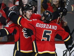 Calgary Flames' captain Mark Giordano congratulates Mikael Backlund on his game-winning goal in overtime during Friday's 3-2 win over the Detroit Red Wings at the Scotiabank Saddledome in Calgary. The victory was Calgary's sixth straight.