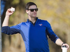 In this Feb. 19 file photo, Ross Atkins tosses a baseball at spring training.