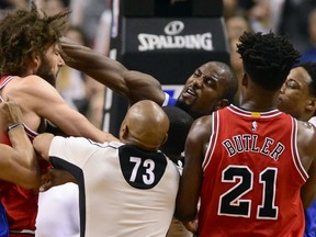 Raptors forward Serge Ibaka strikes out at Chicago Bulls centre Robin Lopez during a scuffle in the second half of their game at the Air Canada Centre in Toronto on Tuesday night.