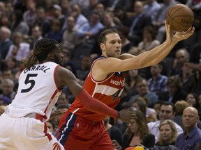 Washington Wizards guard Bojan Bogdanovic looks to pass as the Raptors' DeMarre Carroll defends during second half action in Toronto on Wednesday night.