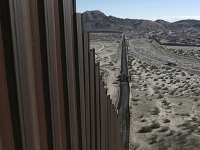 This Jan. 25, 2017, file photo shows a truck driving near the Mexico-US border fence, on the Mexican side, separating the towns of Anapra, Mexico and Sunland Park, New Mexico.