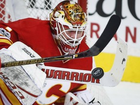 Goaltender Brian Elliott of the Calgary Flames keeps his focus squarely on the puck during NHL action Thursday against the Montreal Canadiens in Calgary. Elliott had 24 saves as the Flames posted a 5-0 victory to extend their winning streak to eight straight, tying a franchise mark.