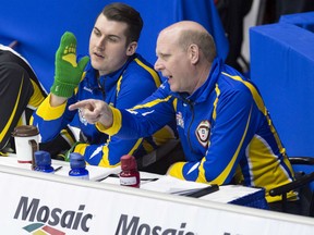 One of Canada's curling greats, Kevin Martin, right, makes a point to Evan Asmussen during action at the Tim Hortons Brier in St. John's, N.L. Monday. Martin, who retired from the sport in 2014, is coaching Brandon Bottcher's rink at this year's Brier. Asmussen is the team fifth. The team also includes Martin's son Karrick.