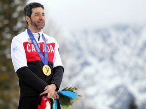 Cross-country skier Brian McKeever poses with his men's 10-kilometre gold medal at the Sochi Paralympics on March 16, 2014.