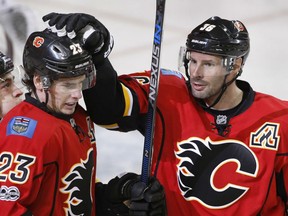Sean Monahan, left, of the Calgary Flames is congratulated by teammate Troy Brouwer afrer scoring during NHL action Monday night in Calgary. Monahan had four points in  leading the Flames to a 4-2 victory over the Colorado Avalanche.