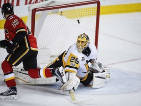 Calgary Flames' Kris Versteeg flips the puck high over the shoulder of Pittsburgh Penguins' goaltender Marc-Andre Fleury for the game-winning goal in a shootout during NHL action Monday night in Calgary. The Flames' 4-3 victory was their 10th straight, tying a franchise record dating back to their days in Atlanta.